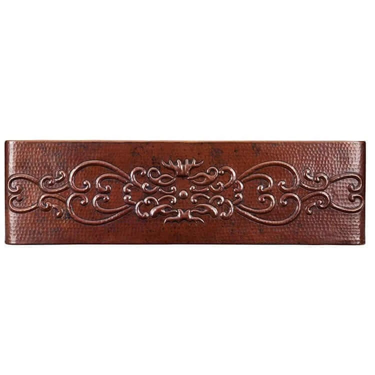 Artisan-crafted decorative brown copper sink front with intricate floral patterns.