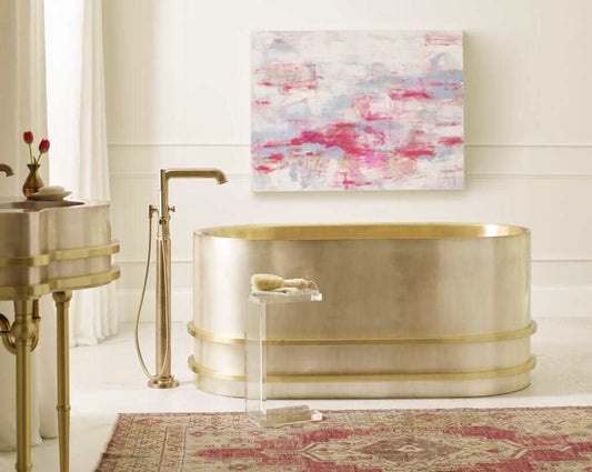 Thompson Quintana Handcrafted Tub in Satin Brass and Burnished Nickel - KCT60 with elegant decor and artistic backdrop.