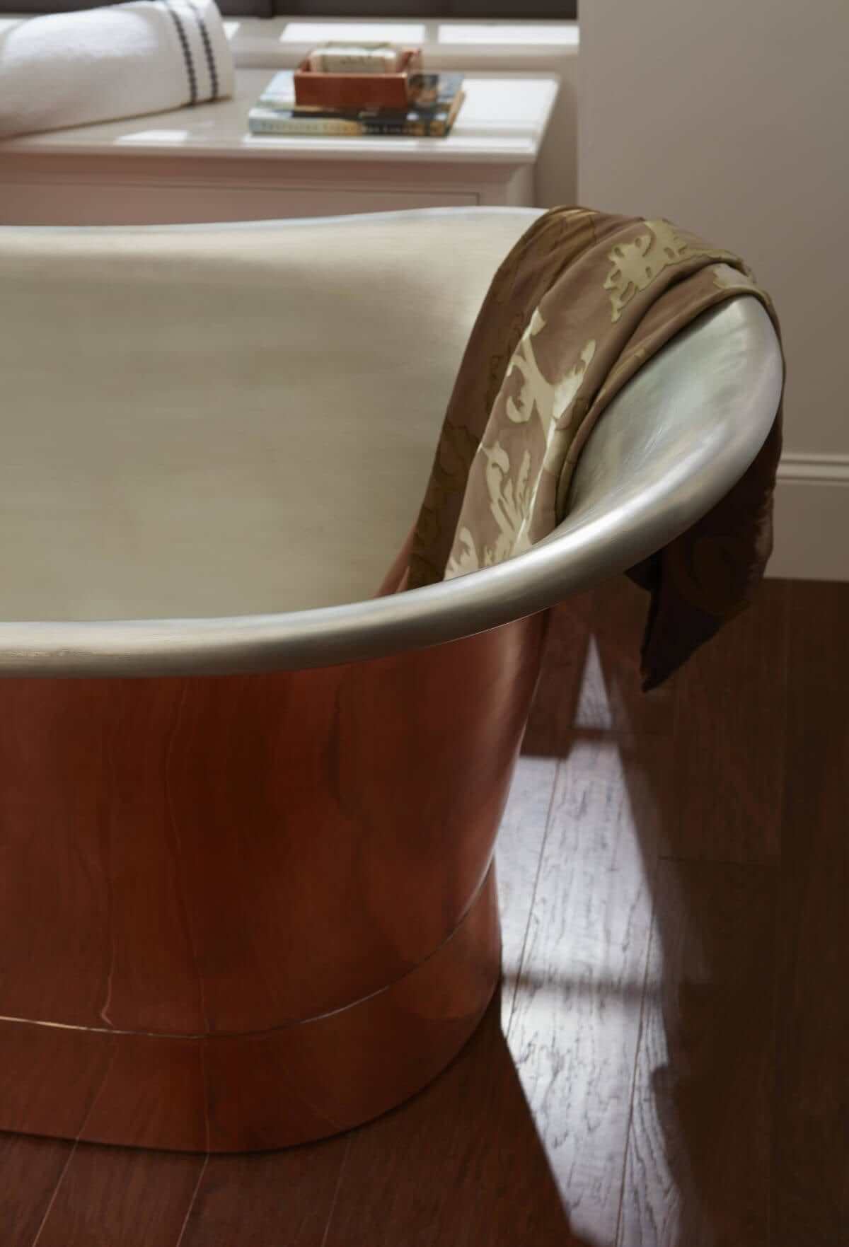 Teaser close-up image of Thompson Traders Coba bathtub with luxurious towel draped on the edge