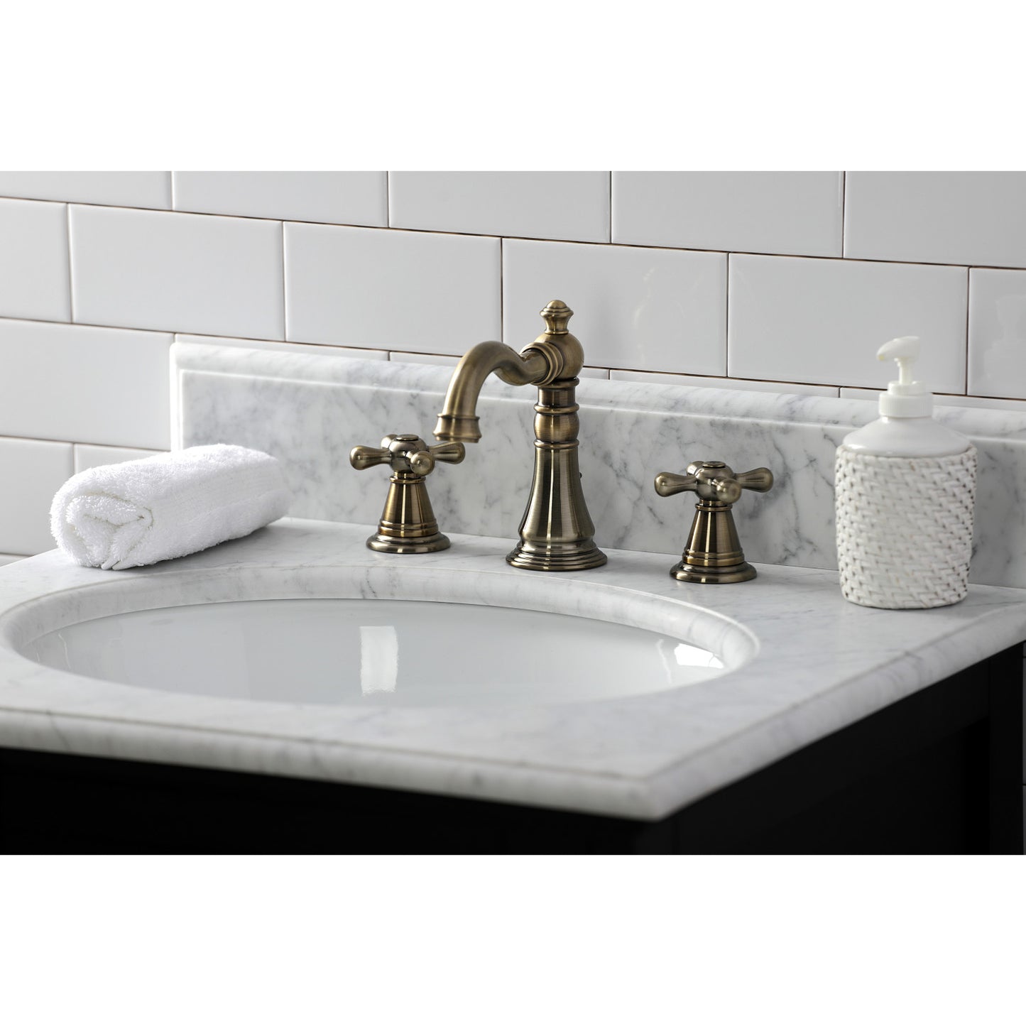KINGSTON Brass Widespread Bathroom Faucet with Pop-Up Drain - FSC1979AAX, close-up view of faucet on marble countertop.