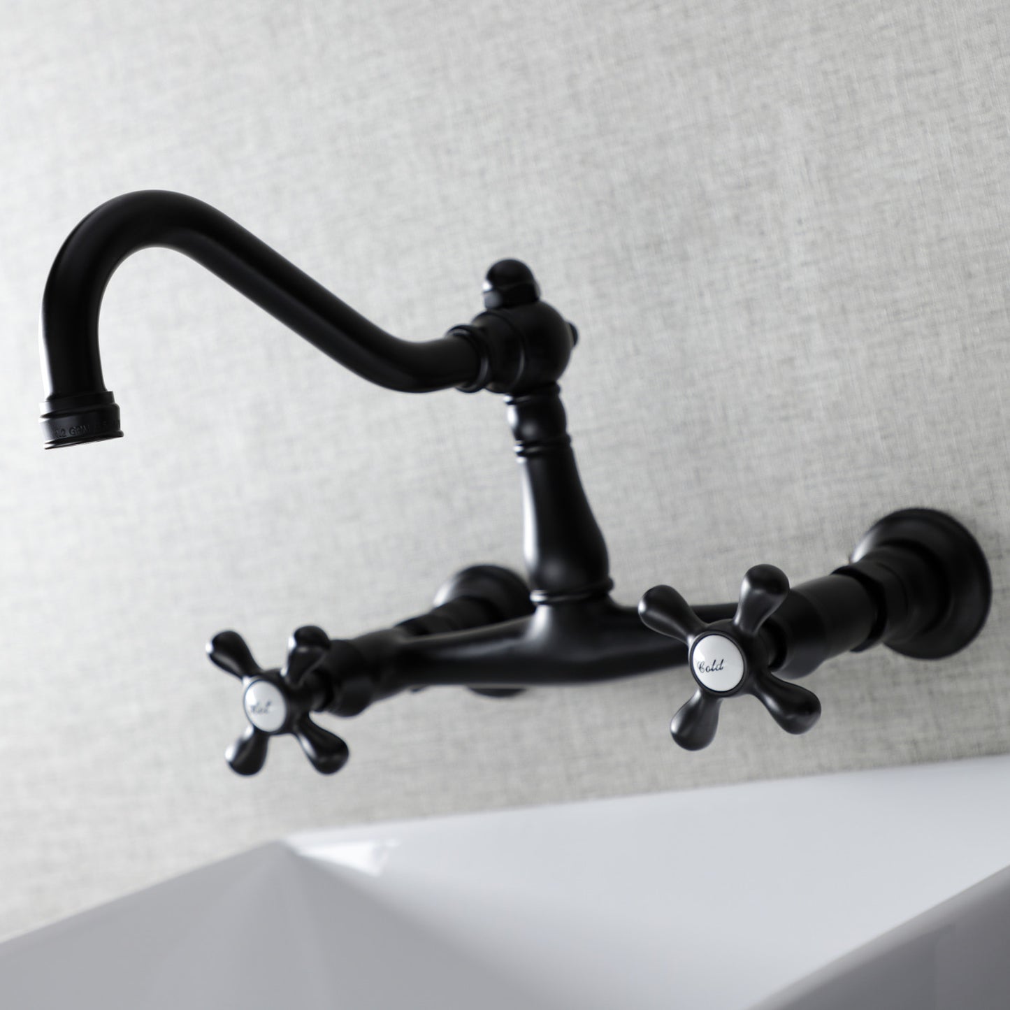 KINGSTON Brass Vintage Wall Mount Bathroom Faucet - KS3245AX left side view with ornate detailing and unique cross handles.