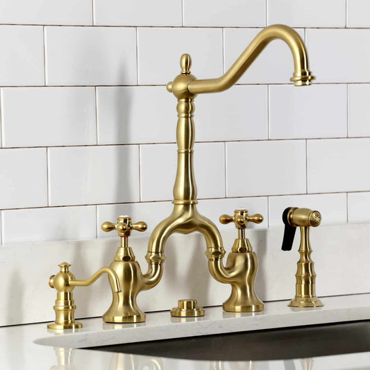 Kingston Brass KS7757AXBS Brushed Brass kitchen faucet set against a white tiled wall