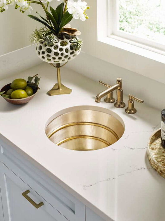 Thompson Quintana 15" Handcrafted Round Bar/Prep Sink - KCBS17 in elegant countertop setting with decor.