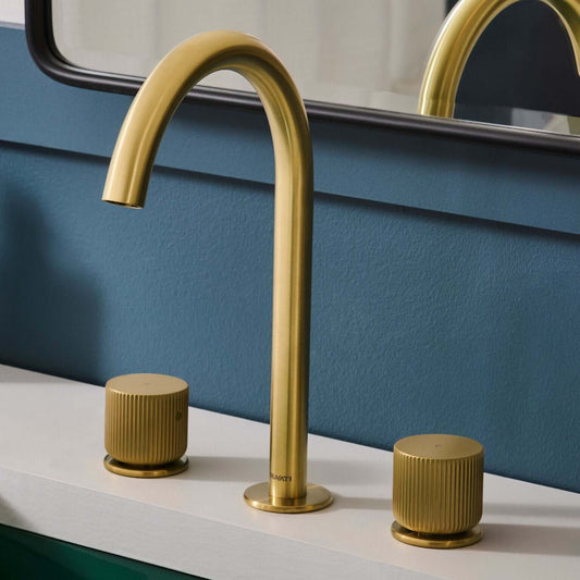 Ruvati RVF5238 Fabio Two-Handle Widespread Bathroom Faucet with Textured Knobs in Brushed Gold on a vanity.