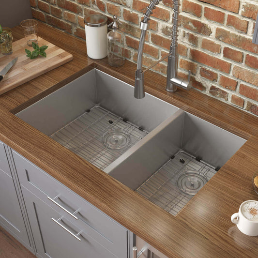 Ruvati 29" Nesta Zero Radius Double Bowl Undermount Kitchen Sink - RVH7200 with stainless steel grids in a modern kitchen.