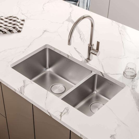 Ruvati 32" Undermount Kitchen Sink 70/30 Double Bowl - RVM5300 installed in a modern kitchen with marble countertop.