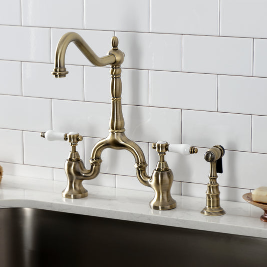 Kingston KS7753BPLBS Bel-Air Bridge Kitchen Faucet with Brass Sprayer, Antique Brass installed in kitchen.