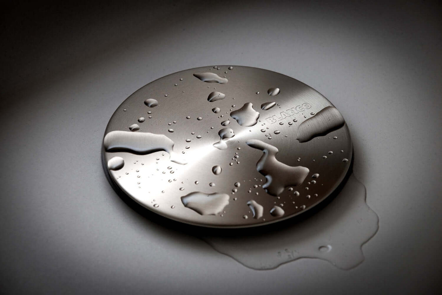 Image showing Blanco Capflow Drain Cover with water drops showing water resistance
