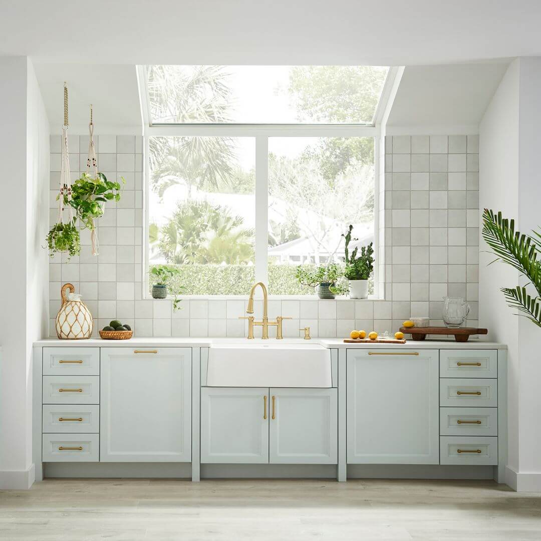 BLANCO Ikon SILGRANIT 33" Single Bowl Apron-Front Farmhouse Sink in a modern kitchen with greenery.
