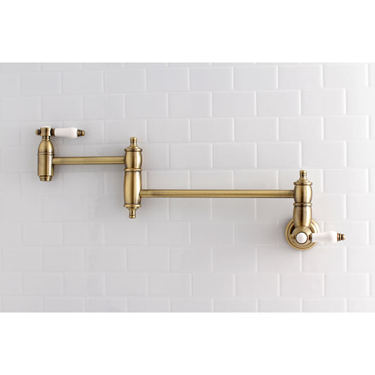 Kingston Brass KS3103BPL Bel-Air Wall Mount Pot Filler Faucet, Antique Brass on a white tiled backdrop.