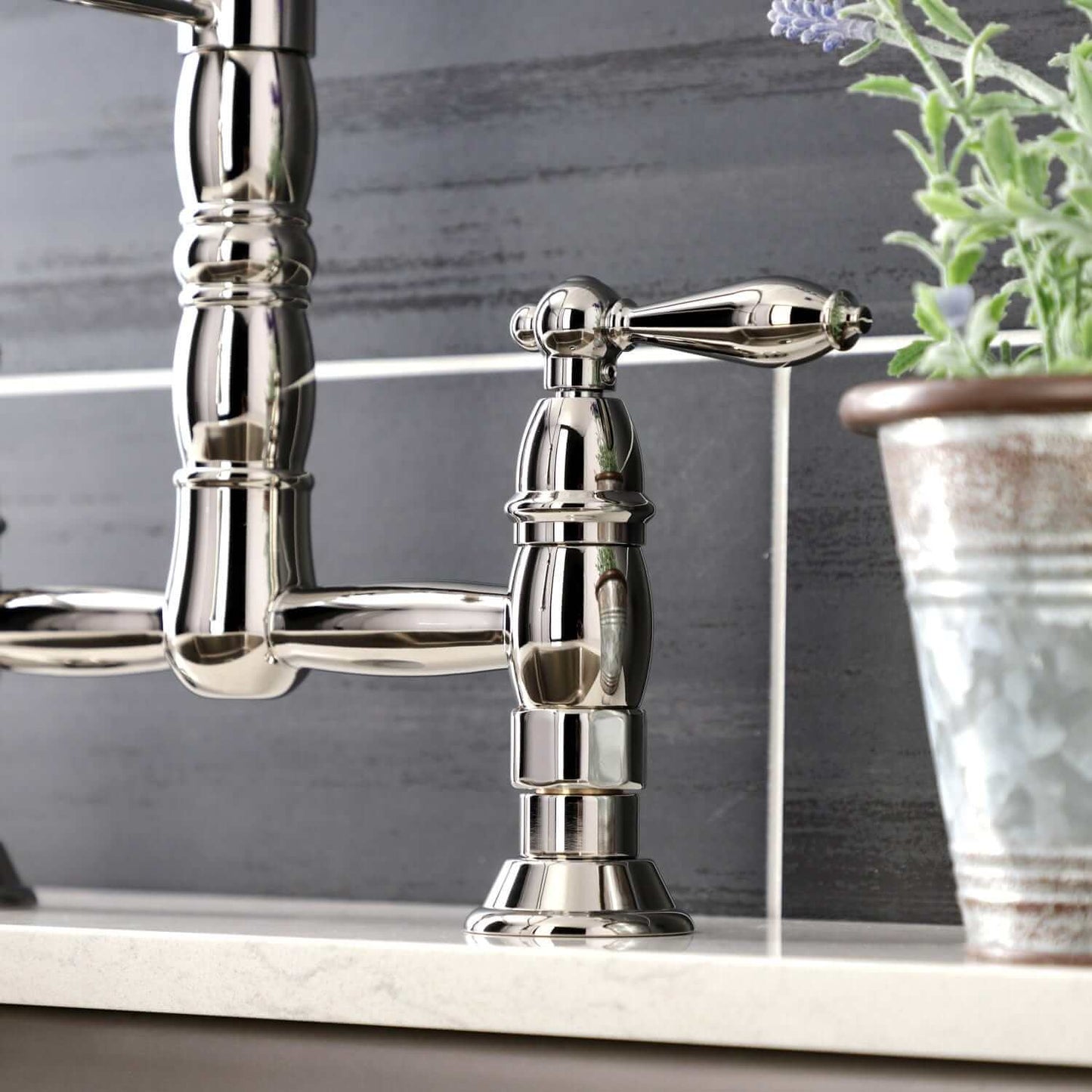 KINGSTON Brass Gourmetier Heritage Two-Handle Kitchen Faucet - Polished Nickel close-up of handle and spout on countertop