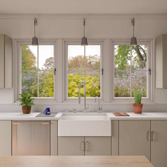 Lifestyle image of Alfi 33" white fireclay farmhouse sink installed in a neutral kitchen