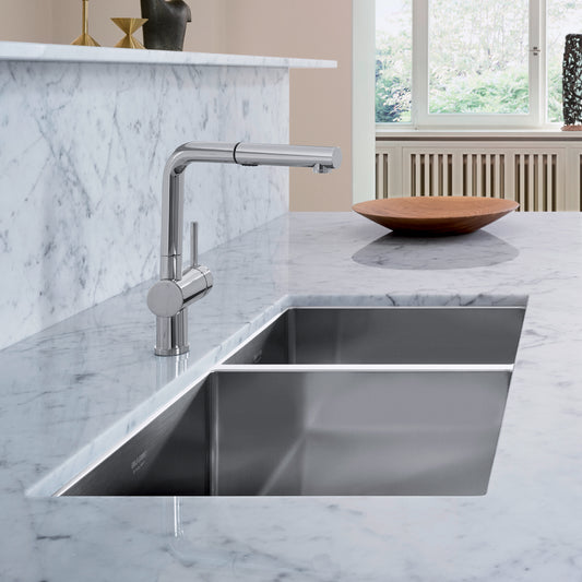 BLANCO Precision R10 33" 60/40 Double Bowl Undermount Stainless Steel Kitchen Sink with modern faucet in marble countertop.