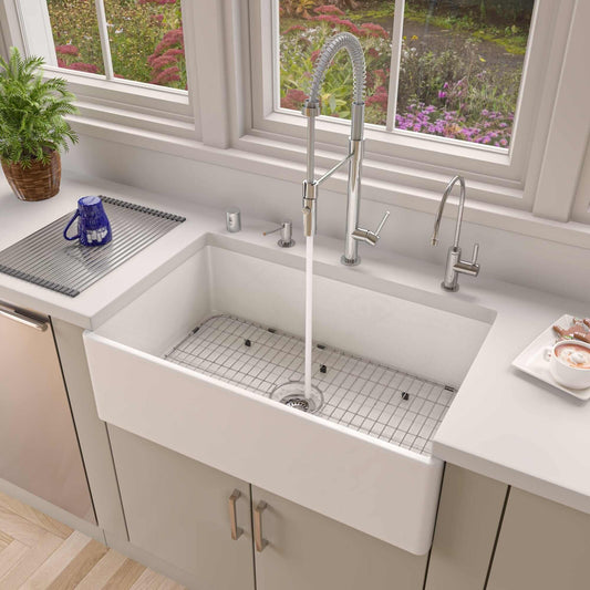 ALFI 33" White Smooth Apron Single Bowl Fireclay Farm Sink AB533-W in modern kitchen setting with faucet.
