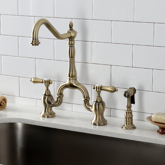 Kingston KS7753BALBS Heirloom Bridge Kitchen Faucet with Brass Sprayer, Antique Brass on a modern kitchen sink.