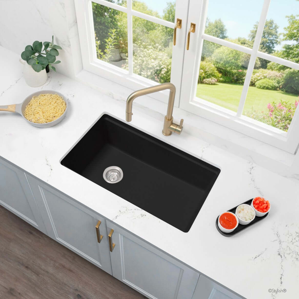 Stylish 32" Composite Granite Workstation Kitchen Sink viewed from above, featuring a sleek black finish and gold faucet.