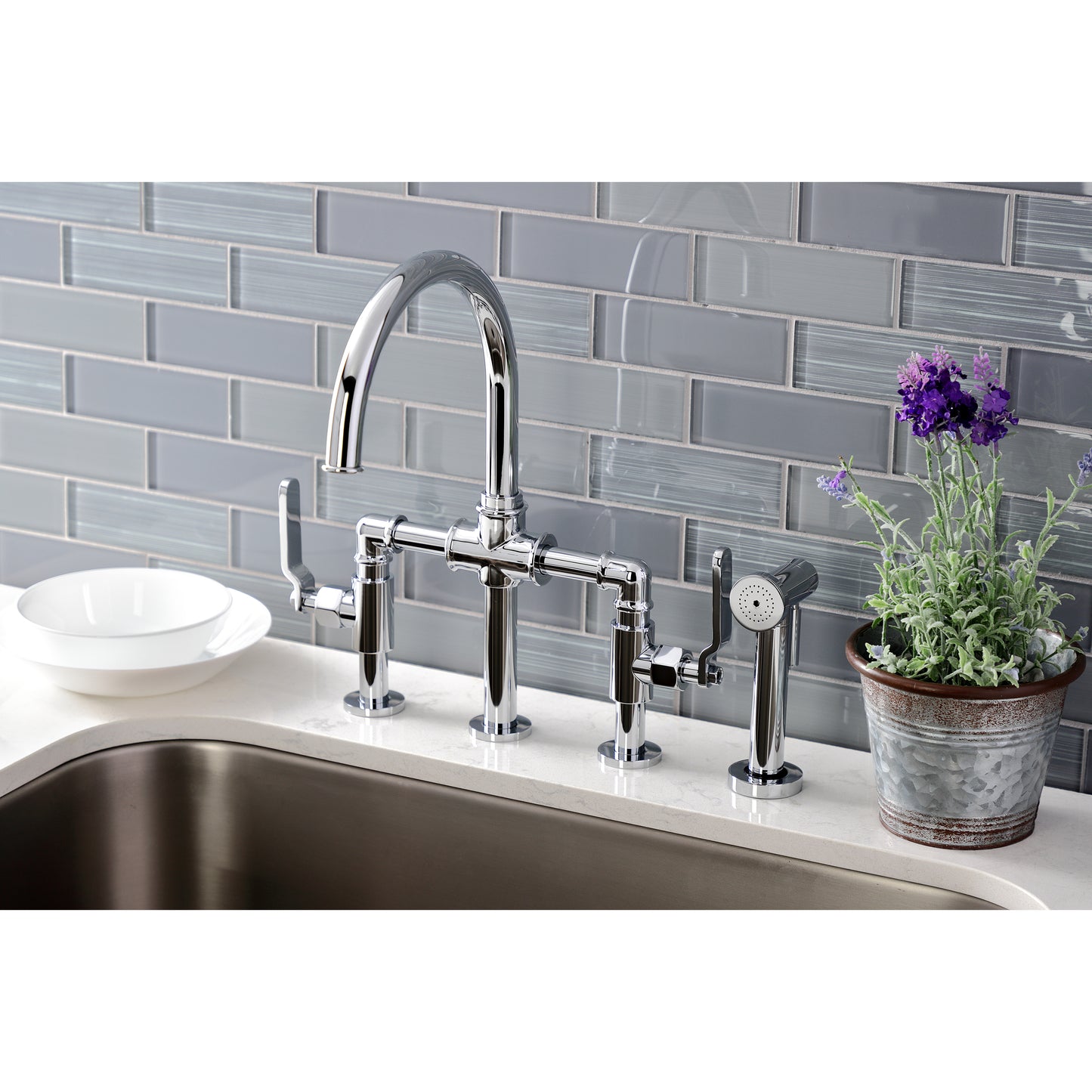 Kingston KS2333KL Whitaker Industrial Style Bridge Kitchen Faucet with Brass Sprayer, Antique Brass in a modern kitchen setting.