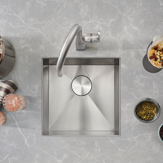 BLANCO Quatrus R0 17" Stainless Steel Undermount Bar Sink with modern faucet and surrounding decorative items.