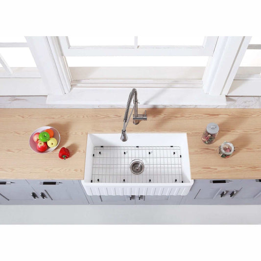KINGSTON Brass Gourmetier 33" Farmhouse Kitchen Sink with Strainer and Grid - Matte White, top view with food items on countertop.