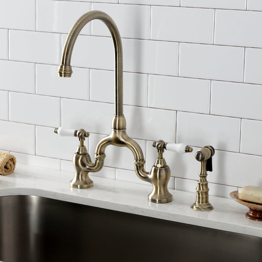 Kingston KS7793PLBS English Country Bridge Kitchen Faucet with Brass Sprayer, Antique Brass in a kitchen setting.
