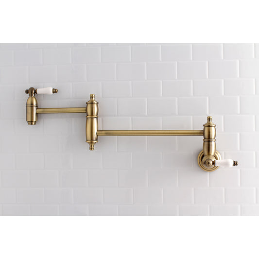 Kingston Brass KS3103PL Restoration Wall Mount Pot Filler Faucet, Antique Brass on a white tiled wall.