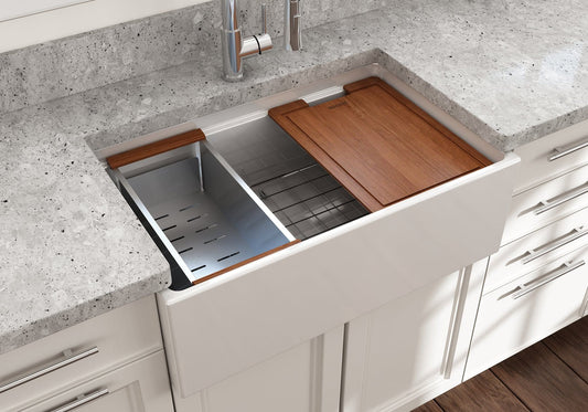Lifestyle image of white Bocchi Contempo 30" sink in a modern kitchen with colander and cutting board in use.