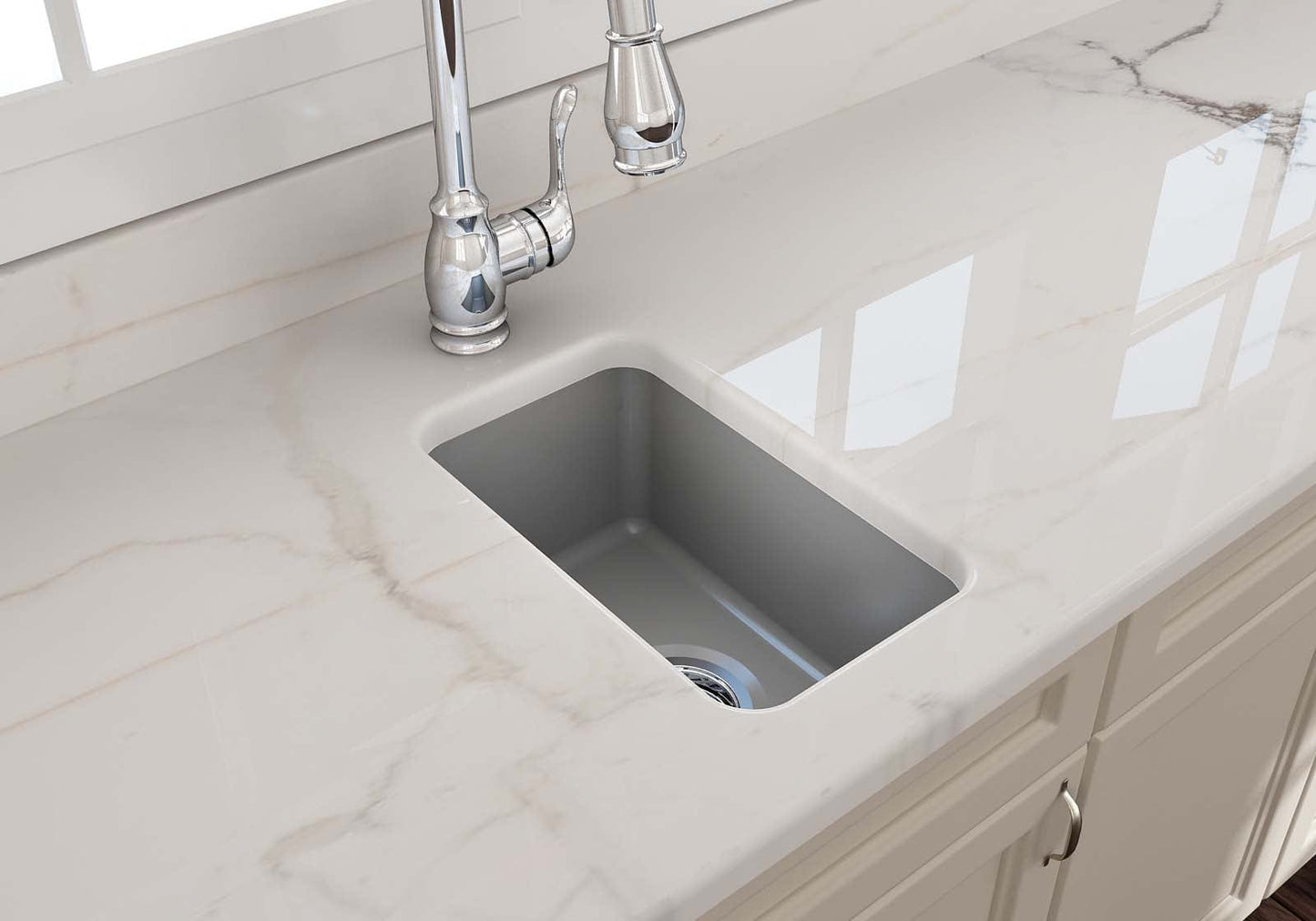 Top view of BOCCHI SOTTO 12" Fireclay Modern Undermount Single Bowl Bar Sink with Strainer on a white countertop.