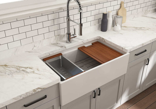 Lifestyle image of white BOCCHI Contempo 33" sink in a modern kitchen with colander and cutting board in use.