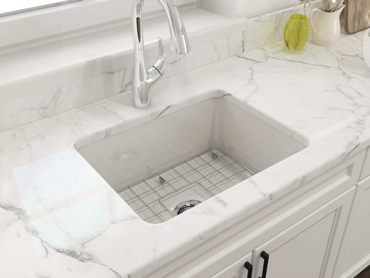 BOCCHI SOTTO 24" Fireclay Dual-Mount Single Bowl Sink with Bottom Grid & Strainer on a marble countertop