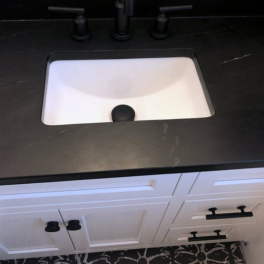 Nantucket 17.125" Undermount Ceramic Bathroom Sink UM-159-W in a stylish black countertop setting.