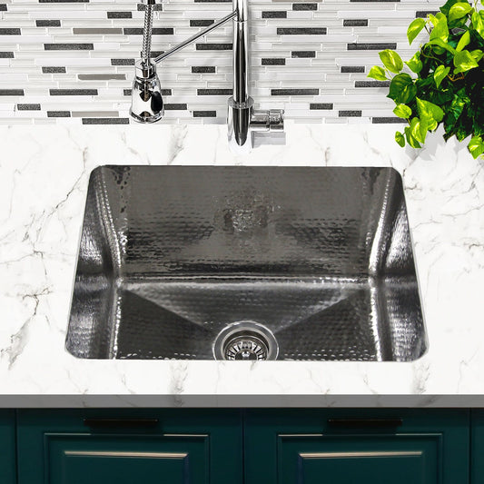 Nantucket 23" Hammered Stainless Steel Rectangle Kitchen/Laundry Sink - KSSH2318-12 installed in a marble countertop setting.