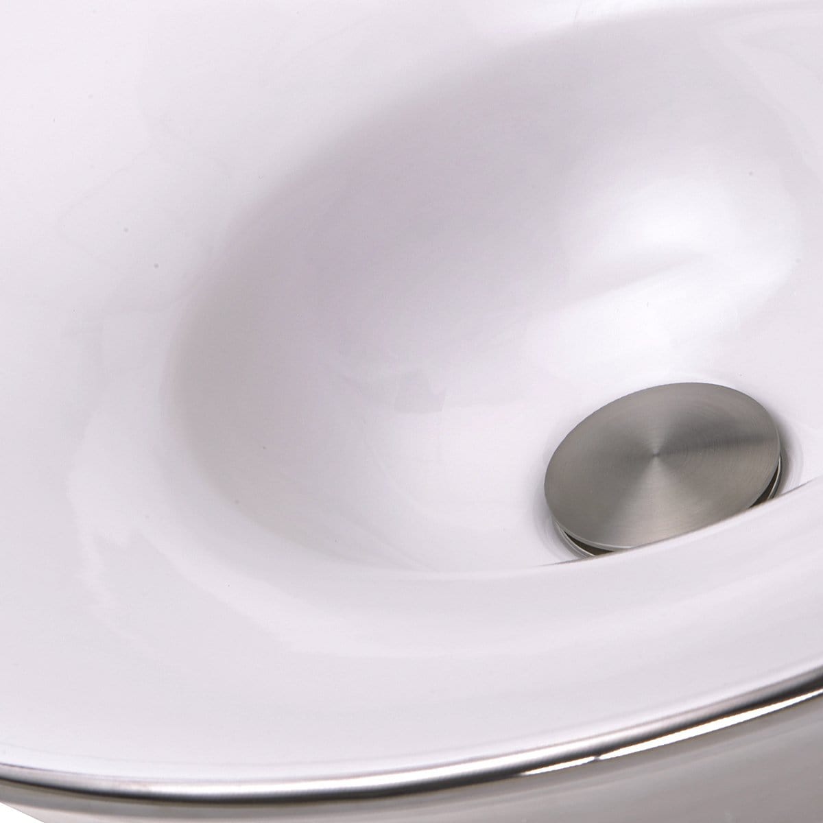 Close-up of the Nantucket St. Malo Italian Fireclay Vanity Sink - RC77240P featuring a smooth white interior and polished drain.