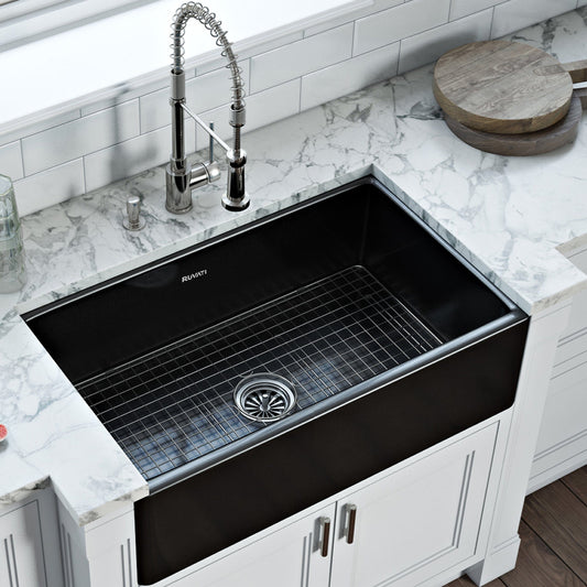 Ruvati Fiamma 33" Fireclay Reversible Single Bowl Kitchen Sink RVL2300BK in glossy black finish on marble countertop.