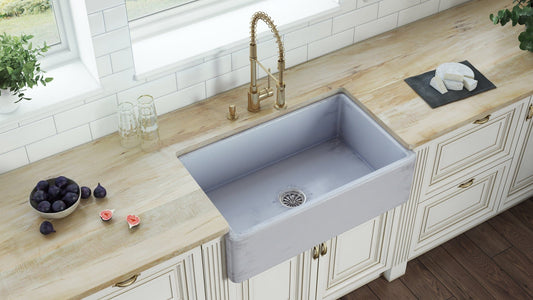 Ruvati Fiamma 33" Reversible Distressed Finish Fireclay Kitchen Sink RVL2300SB installed in a modern kitchen with elegant fixtures.