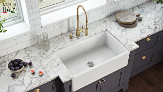 Ruvati Fiamma 33" Fireclay Kitchen Sink RVL2300WH installed in a modern kitchen with marble countertops.