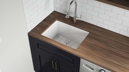 Ruvati Fiamma 24" Fireclay Topmount Kitchen Sink RVL2420WH installed in a modern kitchen with wooden countertop.