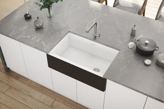 Ruvati Fiamma 30" Offset Drain Fireclay Kitchen Sink RVL4018RBW installed in a modern kitchen with marble countertop.