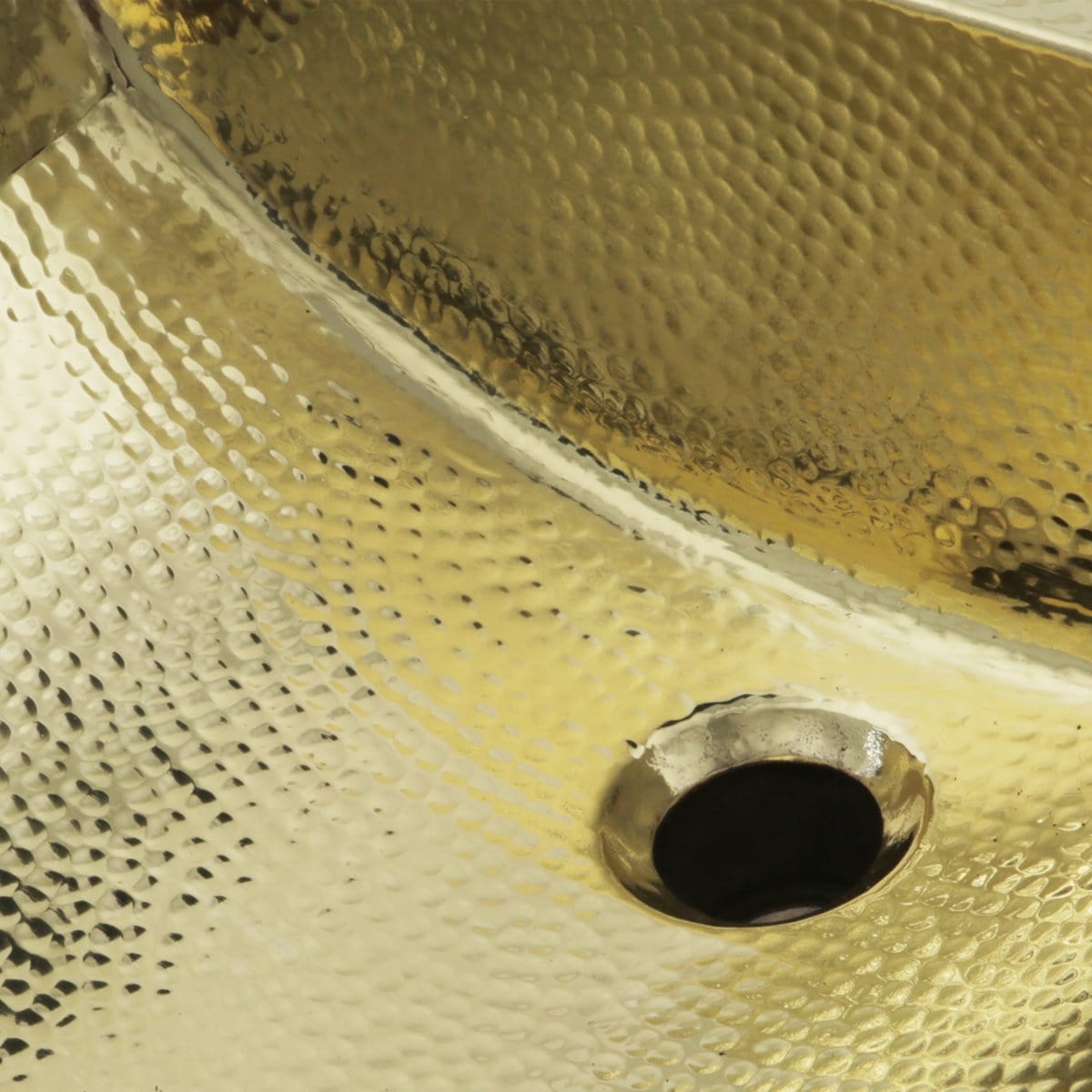 Close-up view of Nantucket 21" Hand Hammered Brass Rectangle Undermount Bathroom Sink with Overflow - TRB-1914-OF showing unique texture.