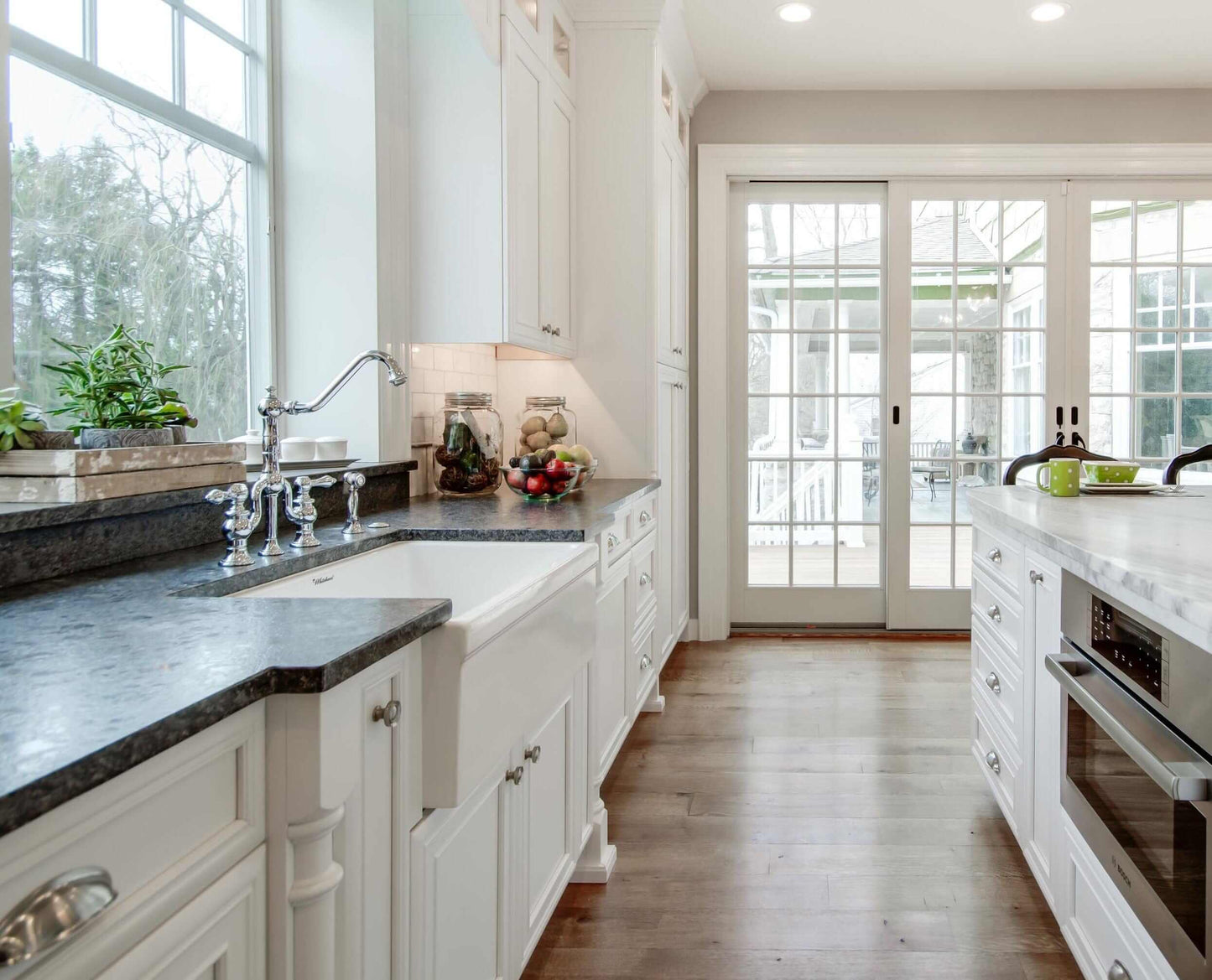 WHITEHAUS 30" Glencove Fireclay Reversible Sink WHQ5530-BLACK showcased in a modern kitchen with white cabinets.