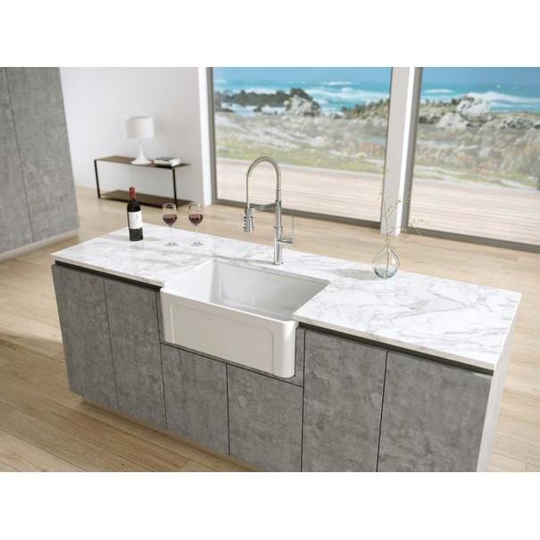 Latoscana 27" Reversible Fireclay Single Bowl Farmhouse Sink front view in modern kitchen setting with marble countertop.
