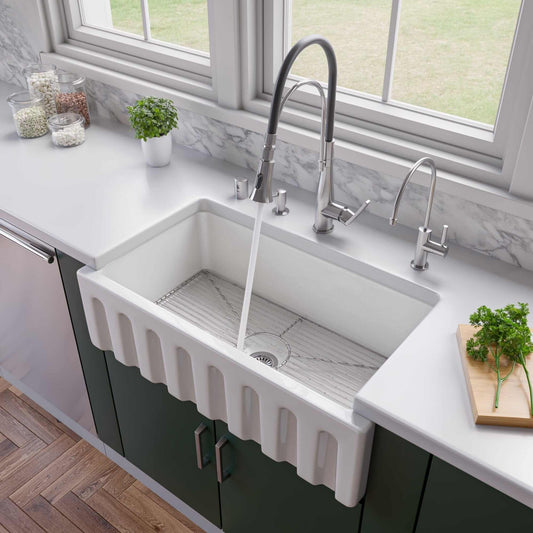 ALFI 33" Reversible Fluted / Smooth Single Bowl Fireclay Farm Sink AB3318HS-W with fresh herbs and modern faucet.