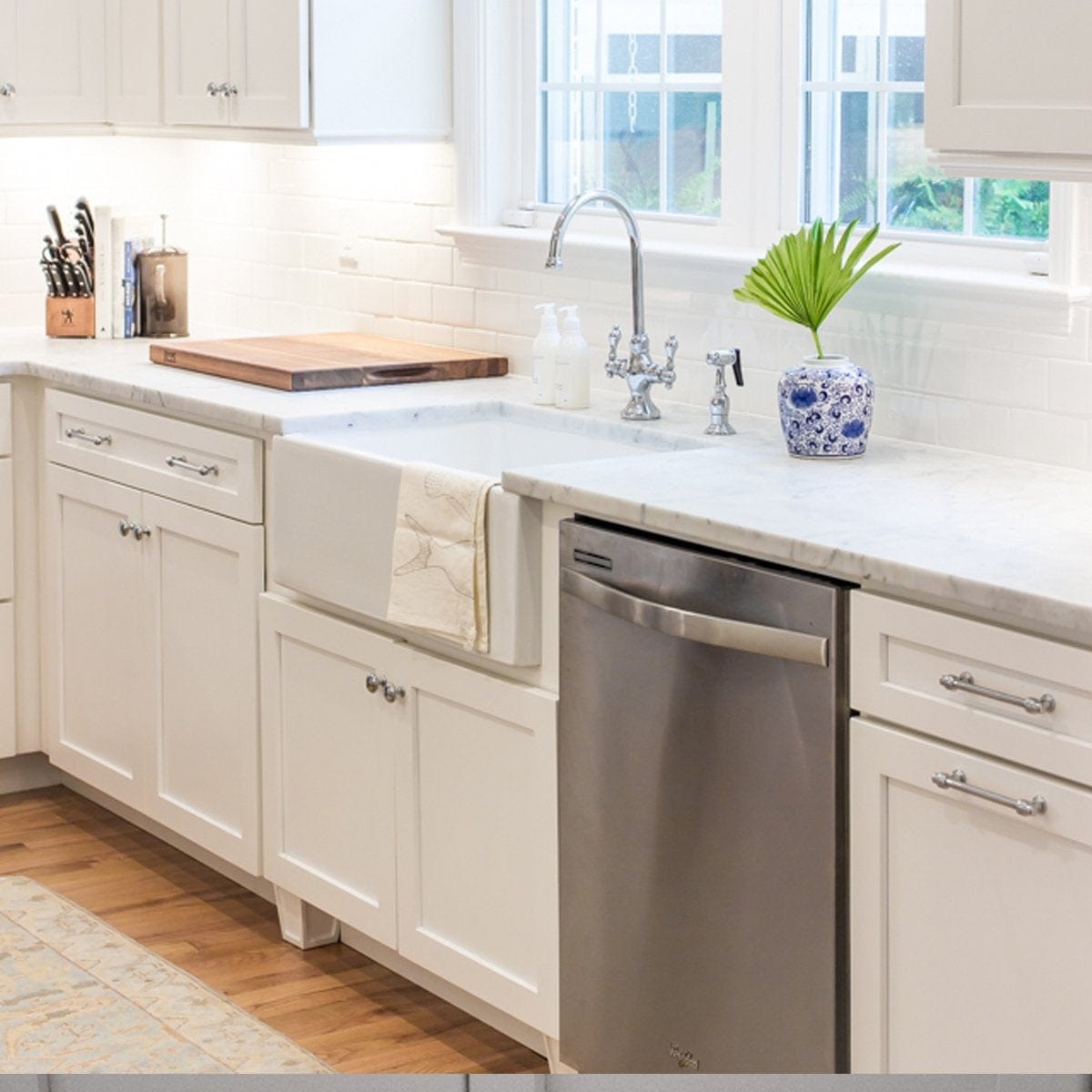 Nantucket 30" Italian Farmhouse Fireclay Sink - Hyannis-30 in a modern kitchen with white cabinetry and stainless steel appliances.