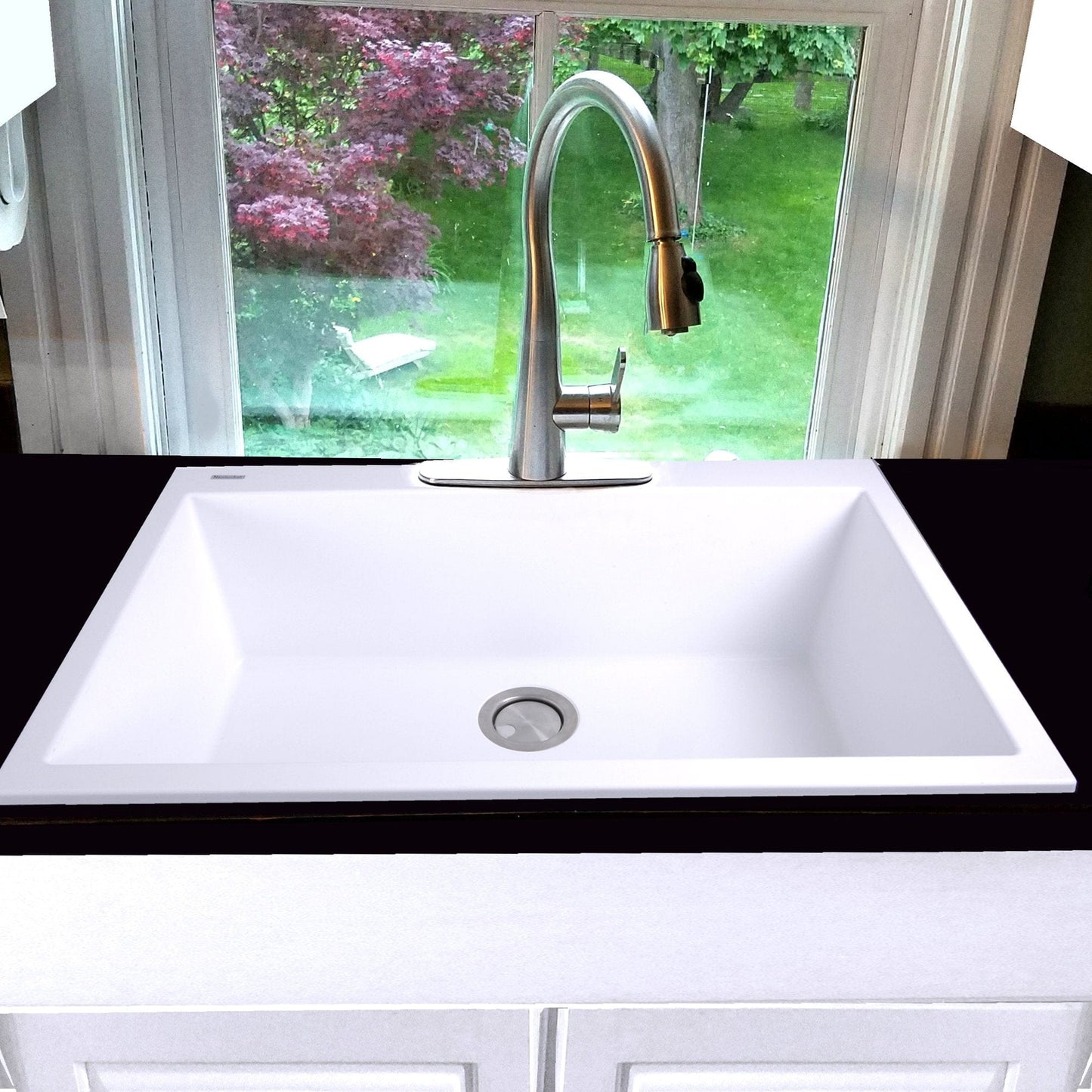 Nantucket 33" Dual-Mount Granite Composite Kitchen Sink White with sleek faucet and garden view.