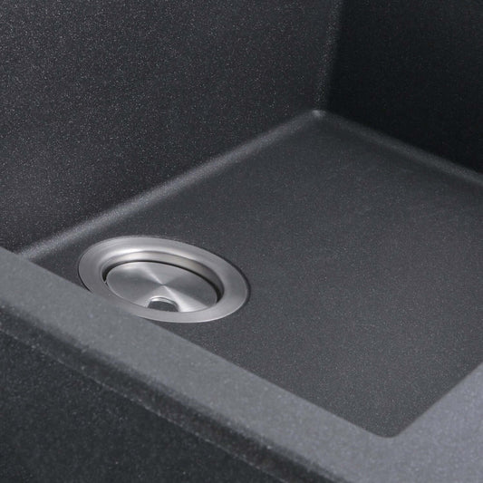 Nantucket Large Single Bowl Dual-Mount Granite Composite Black close-up of sink drain in a spacious black sink interior.