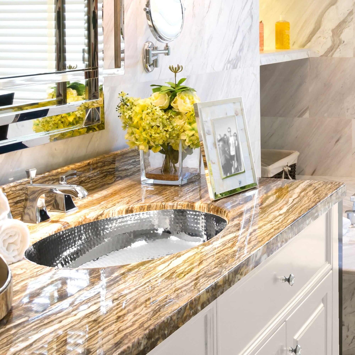 Nantucket Hand Hammered Stainless Steel Oval Undermount Bathroom Sink - OVS in elegant bathroom with stylish countertop.