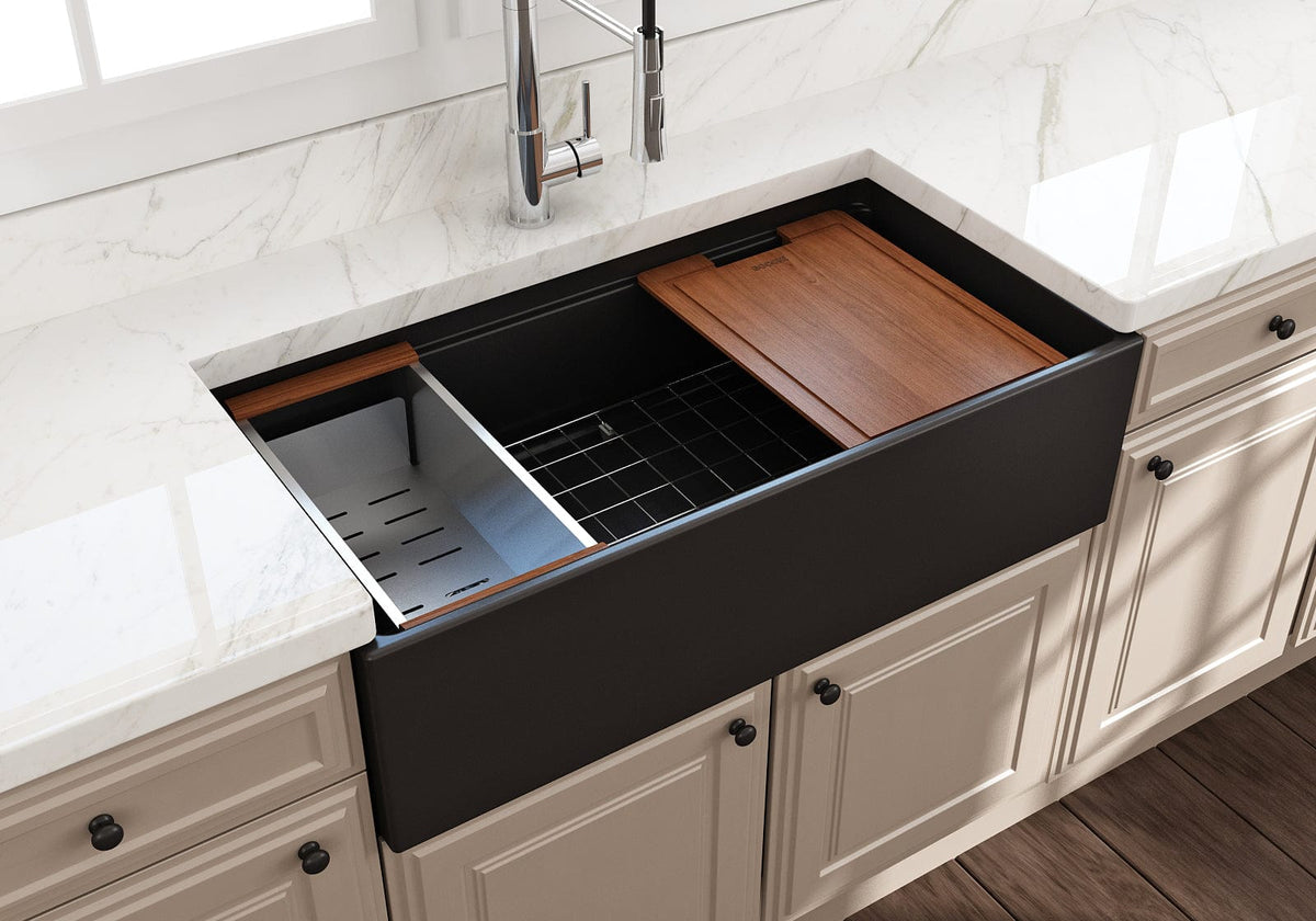 Matte black fireclay workstation farmhouse sink with white marble countertop and white cabinets