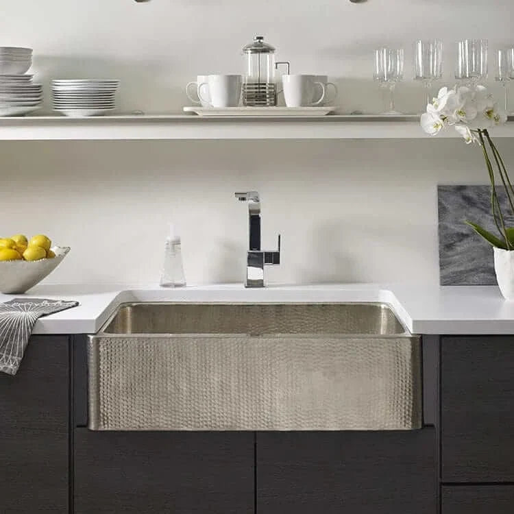 Thompson Quiroga 33 inch hammered stainless steel farmhouse sink installed in a modern kitchen