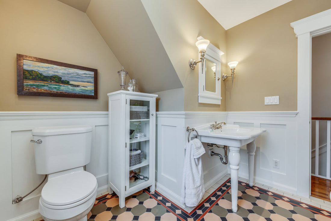 Victorian-style bathroom with a clawfoot tub and white console sink on turned legs