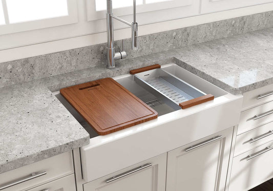 BOCCHI NUOVA 34" Single Bowl Kitchen Sink with Protective Bottom Grid and Strainer features a wooden cutting board and a stone countertop.