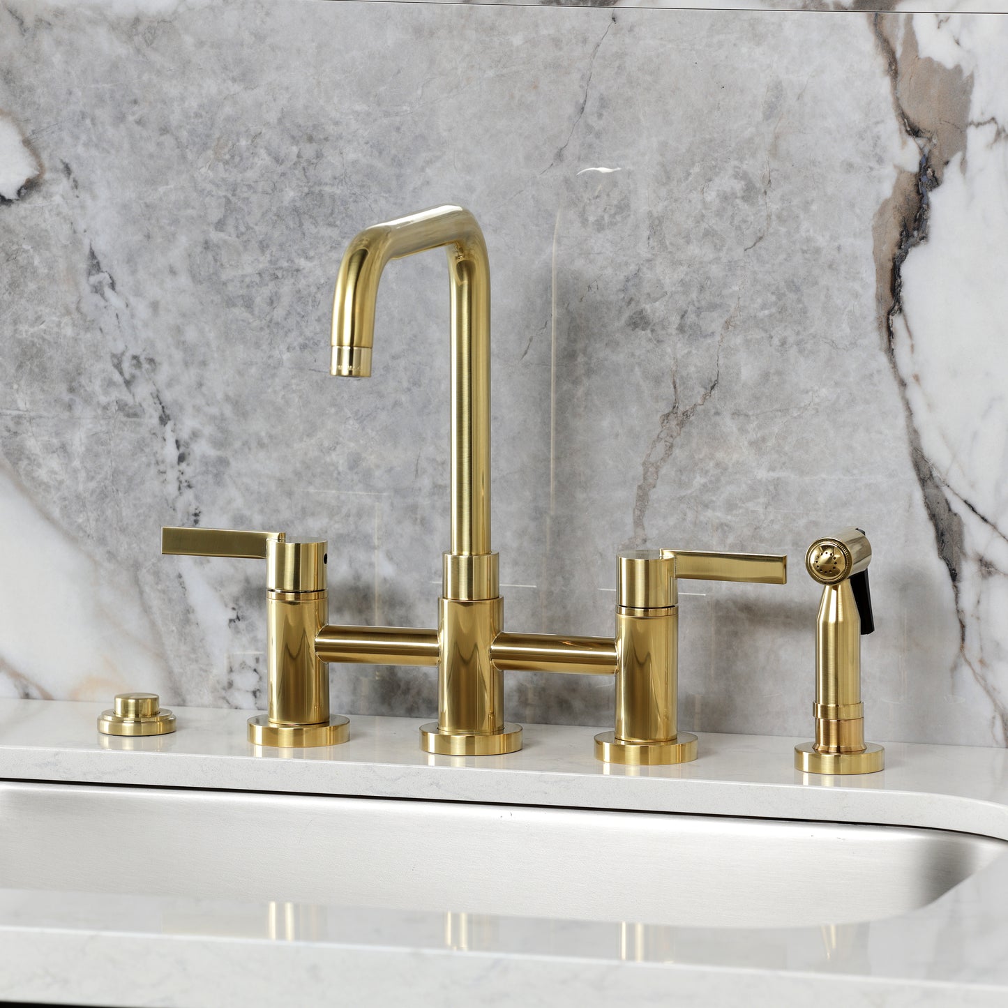 Kingston KS8287CTLBS Continental Bridge Kitchen Faucet with Brass Sprayer, Brushed Brass on a kitchen counter.